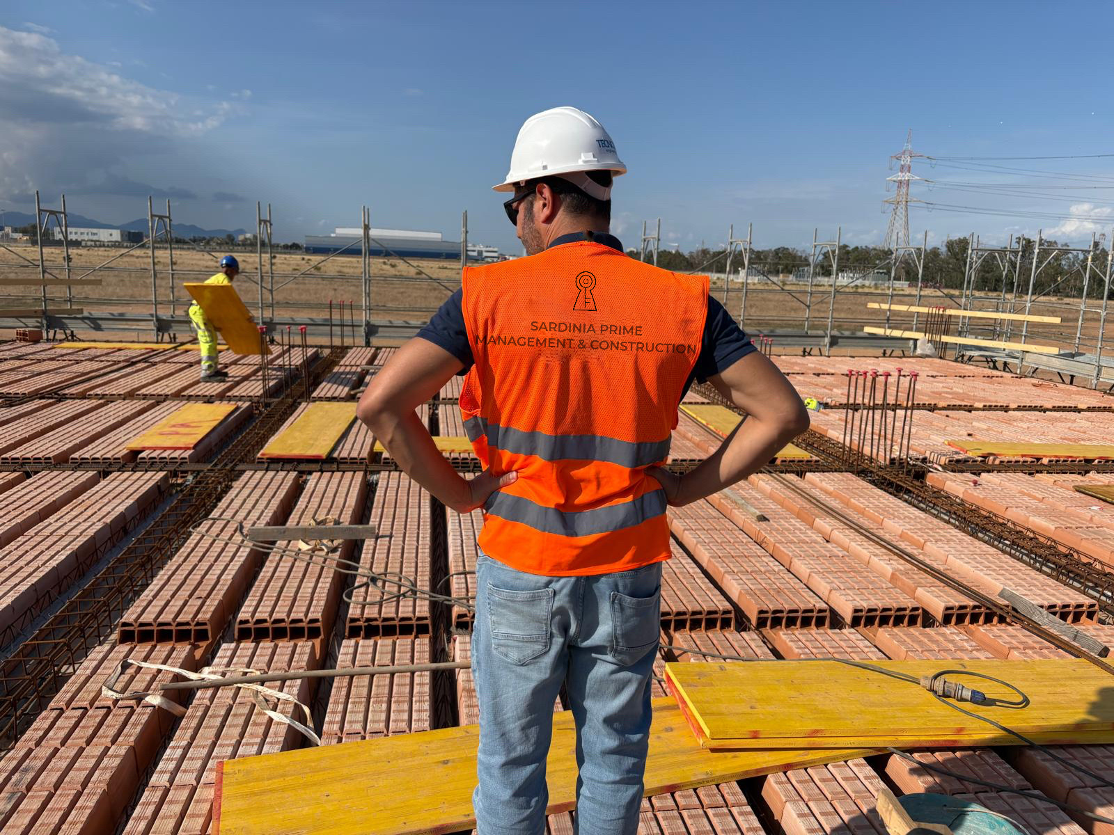 Chartered Engineer verifying structural details on luxury construction site Sardinia